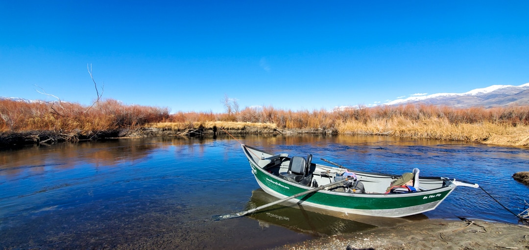 A drift boat from an Eastern Sierra Fishing Guide on the banks of the Lower Owens River near Bishop, CA.