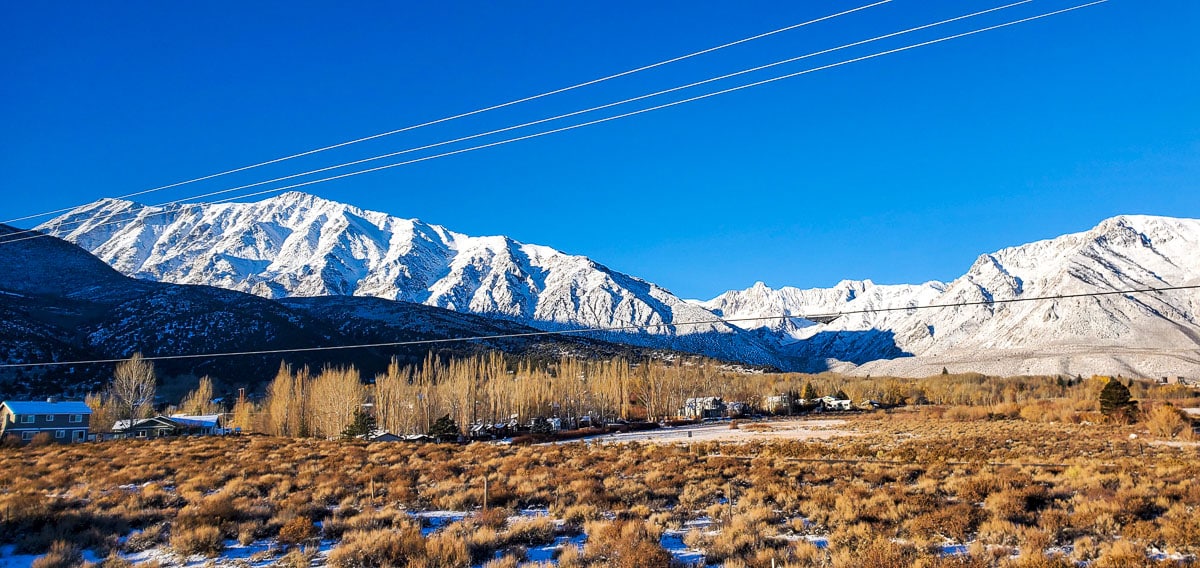 Community of Crowley Lake and McGee Mountain with fresh snow capped mountains and clear skies