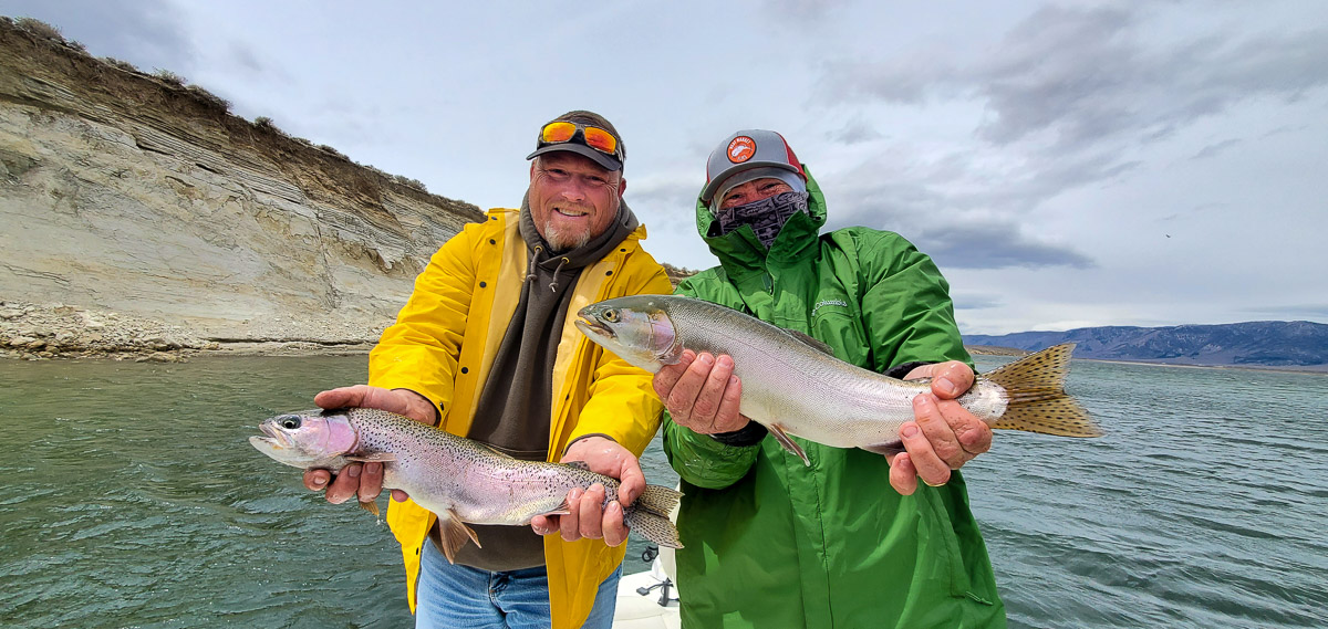 A pair of fly fishermen with a double hookup on rainbow and cutthroat trout on Crowley Lake.