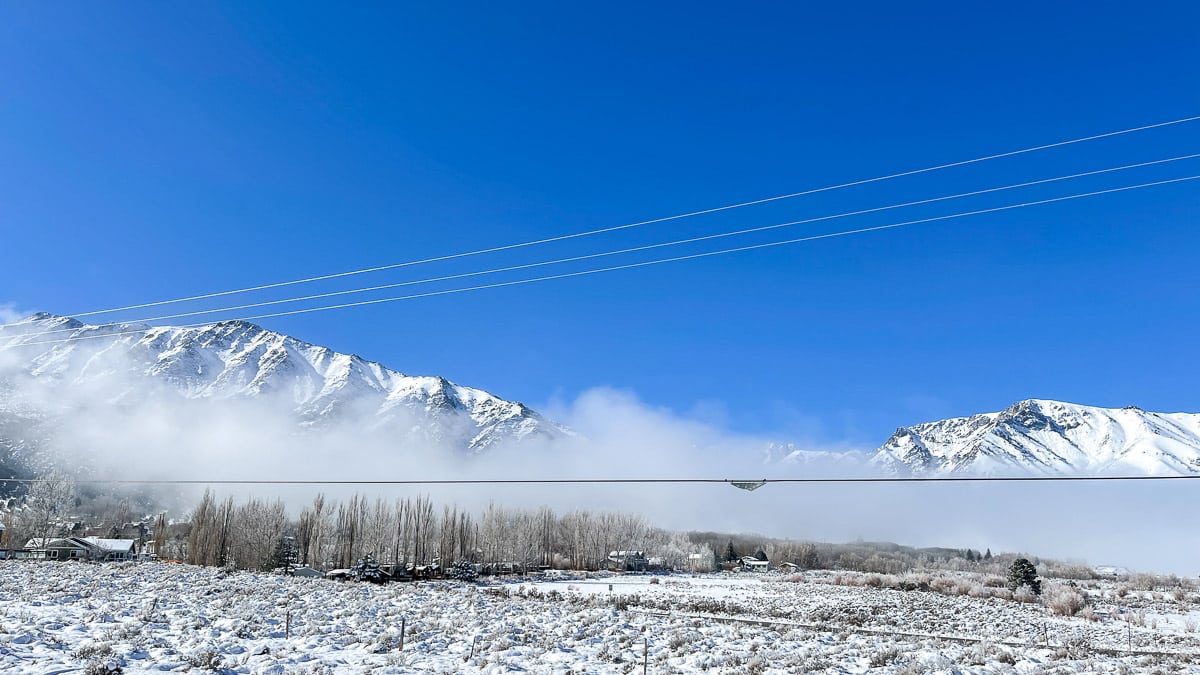 Morning fog covering up a mountain range in the winter.