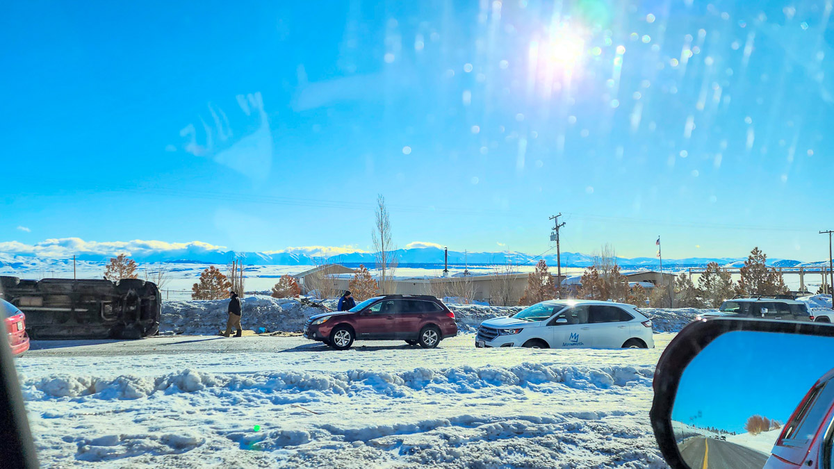 A traffic slowdown on US Highway 395 with an overturned vehicle.