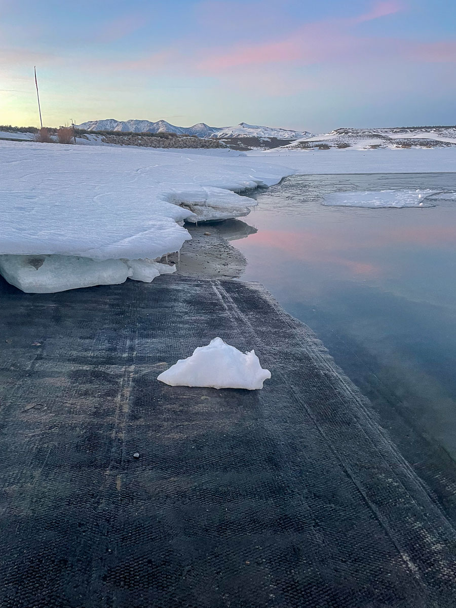 A snow and ice covered shorline on the launch ramp of Crowley Lake.