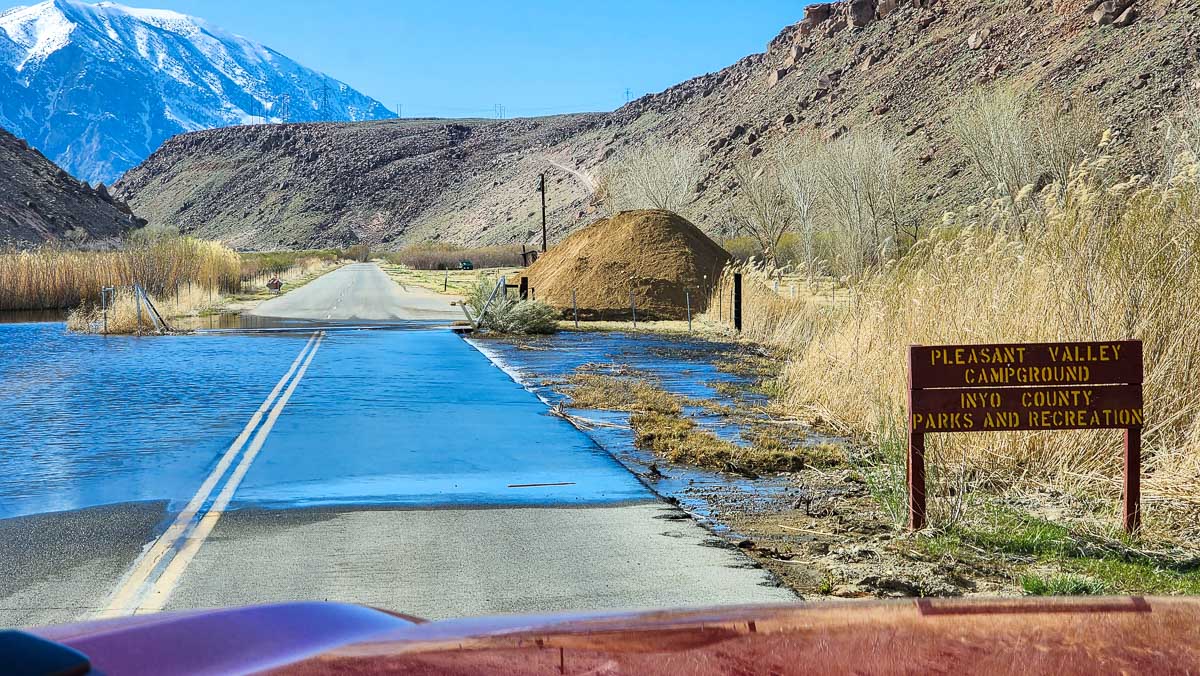 A river flowing over a roadway in the eastern sierra at Pleasant Valley Campground.