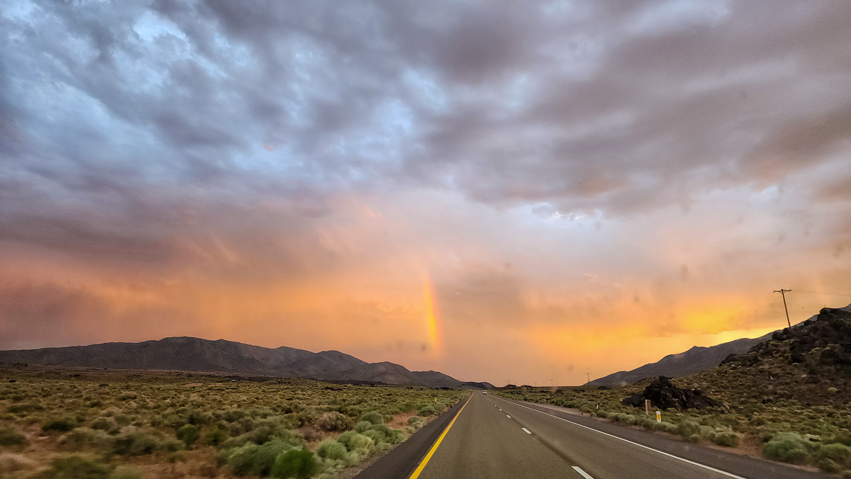 A rainbow shows inside a thunderstorm in the eastern sierra.