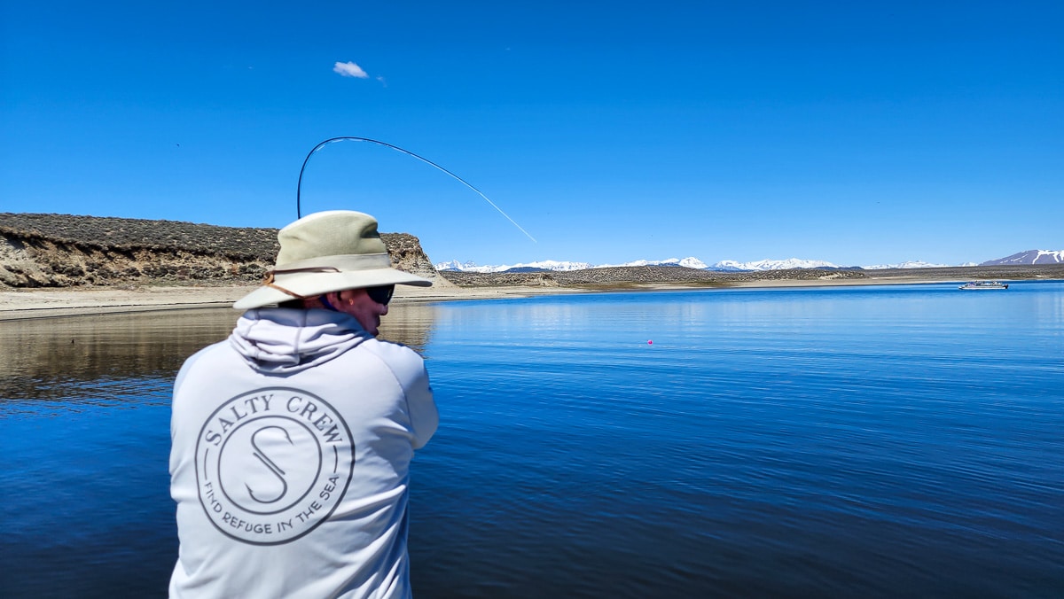 A fly fisherman fighting a nice trout from Crowley Lake.