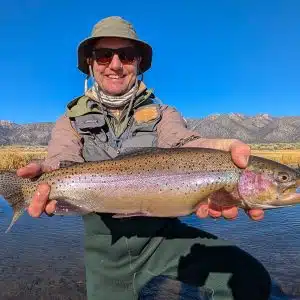 A meandering river in the sierra nevada in California with snowy mountains in the background.