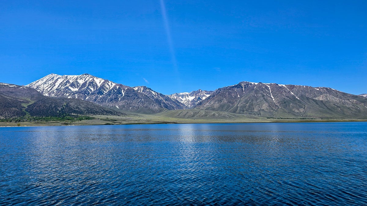A view of Crowley Lake from the water looking toward Mammoth Mountain in the Eastern Sierra.