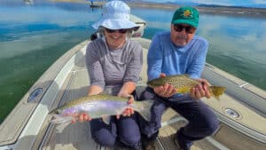 Two fly fishermen holding a large rainbow and brown trout from Crowley Lake near Mammoth Lakes, CA